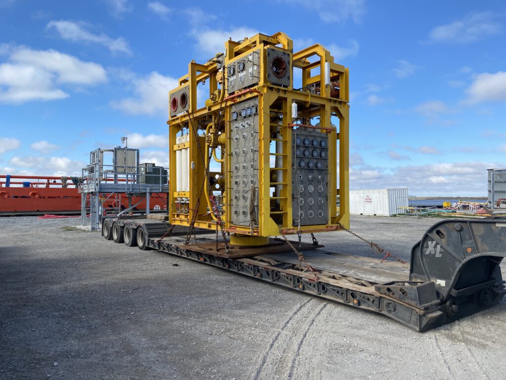 Subsea equipment transport Houston using a lowboy trailer to move an oversized subsea module.